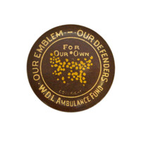 Image: small circular badge with text and wattle flower depiction in the centre