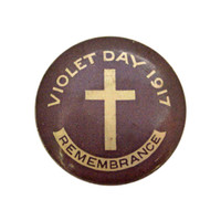Image: purple badge with cross and white text