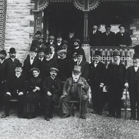 Image: The German consul sitting surrounded by his welcoming party at the front of a house in Hahndorf
