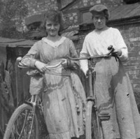 Image: two girls standing outside with their new bicycles