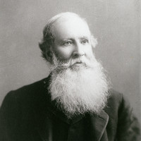 Image: Portrait of a man with a white beard and dark jacket