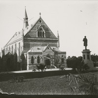 Image: view of a conservatorium building with a statue of a man in front