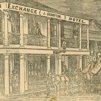Image: A coach and four stands outside the Exchange Hotel, a two storey building with large windows on the ground floor. A lady and gentleman look on from the balcony.