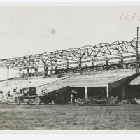 Image: Construction of a grandstand with old vehicle in the foreground.