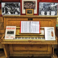 Image: upright piano covered in signatures