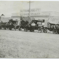 Image: Black and white photograph of three trucks outside Alf Hannaford & Co store
