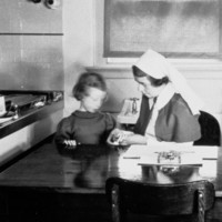 Image: woman in nurses uniform with young girl