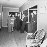 Image: people standing at reception desk 
