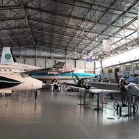 Image: group of planes in large hanger style building
