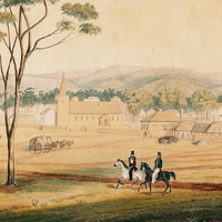 Image: a watercolour painting of two men riding through a field which backs on to a row of small wooden cottages and a small church, all behind a wooden fence.