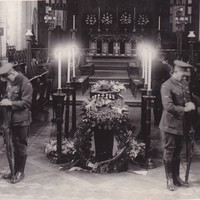 Image: Two soldiers standing guard next to a casket 
