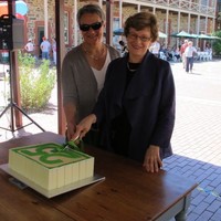 Image: two women cutting cake
