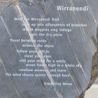 Image: A rough stone monument with text inscribed on a single polished flat face. The text is a poem entitled ‘Wirranendi’