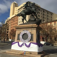 Image: large wreaths of woollen violets on statue of horse and rider