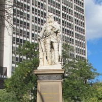 Image: stone statue of man on stone pillar