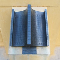 Image: metal sundial in two curved halves