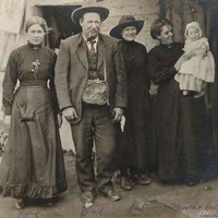 Image: group of people, old woman on right holding young baby in arms