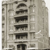 Image: Black and white photograph showing the Liberal Club building as it appeared in 1927. It shows the building old cars with canopy style roofs sitting out the front.