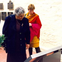 Image: two women looking at large outdoor plaque