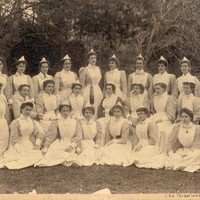 Image: A black and white image of Margaret Graham surrounded by other nurses