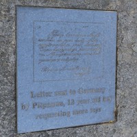 Image: bronze engraved plaque set in granite boulder