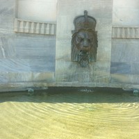 Stone Lions head with water coming out from mouth