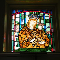 Stained glass window of Mary holding her son