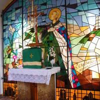 Large stained glass window behind a church altar