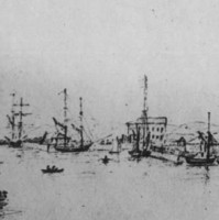 Image: A number of sailing ships are moored in a river. A scattering of buildings and a wharf are visible in the background