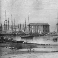 Image: A number of sailing ships are moored in a river. A cluster of buildings and wharves are visible in the background. A rowboat discharges people in the right foreground