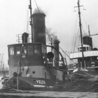 Image: A line of three tugboats tied up at a wharf. The tug in front has the name ‘Yelta’ painted on its bow 