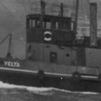 Image: A tugboat with ‘Yelta’ painted on its bow underway in an active port. A number of large ships and a wharf are visible in the background