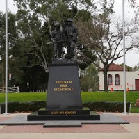 Image: Black memorial monument for the Vietnam War, front of memorial.
