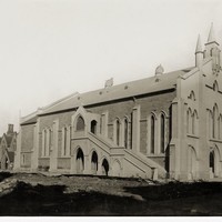 Image: This image shows the Wesleyan Church in 1925. The black and white image shows the church's front and side view, with a group of bicycles leaning up against the side of the building and a 1920s era car in the distance. 