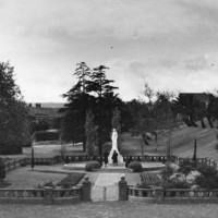 Image: walled garden with stone statue in middle
