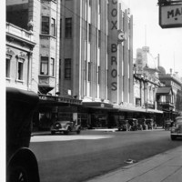 Image: Large department store in Art Deco style dwarfing the adjacent cinema