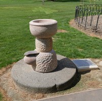 Marble drinking fountain with lawn in the background