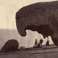 Image: people in front of large rock formation