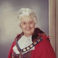 Woman wearing mayoral robes and wig. 