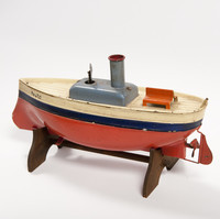 Image: toy boat made of metal and painted red, blue and cream