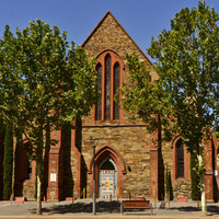 Image: stone church building with high central steeple