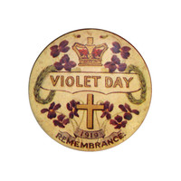 Image: small circular badge with violets, cross and crown pictures