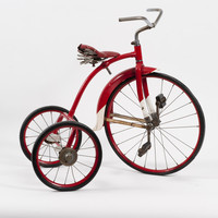 Image: Red metal bike with three wheels