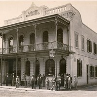 Image: men standing in front of building 