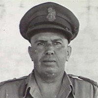 Image: Photographic head-and-shoulders portrait of a middle-aged Caucasian man in the uniform of a high-ranking Australian Army officer