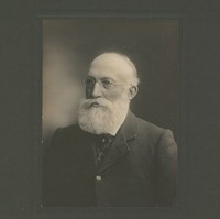 Image: A photographic portrait of an elderly man with a full, white beard and wire-rimmed glasses
