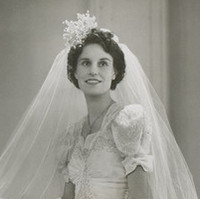 Image: A young Caucasian woman poses for a photograph in her 1940s vintage bridal gown