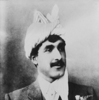 Image: black and white photo of man in suit wearing white turban