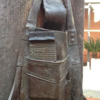 Image: bronze sculpture of pad in an apron pocket