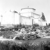 Image: Glasshouse surrounded by a rockery garden